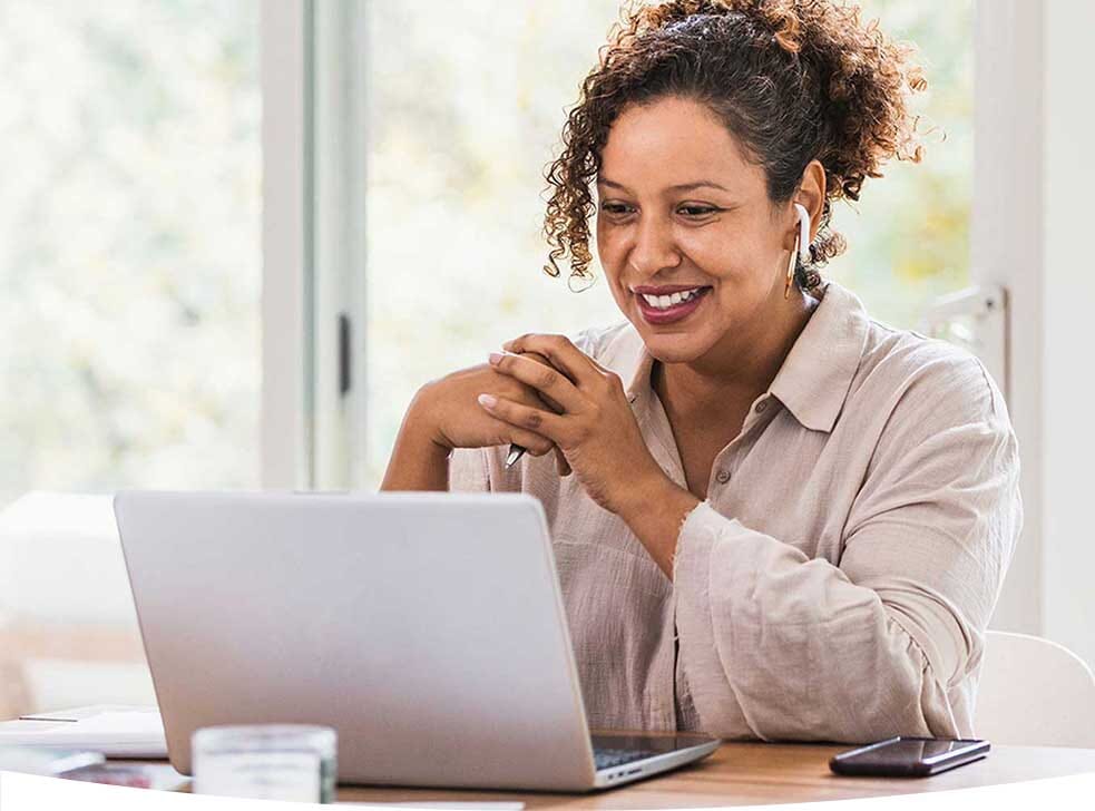 Woman smiling at her computer