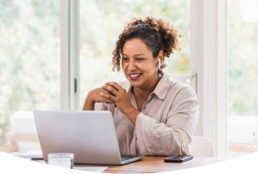Woman smiling at her computer