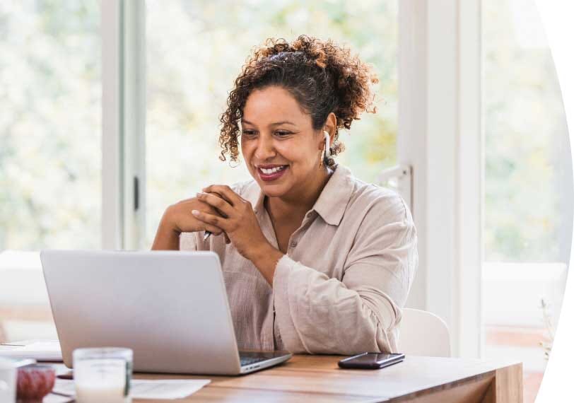 Woman smiling at her computer