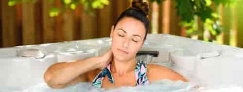 female in hot tub with neck pain